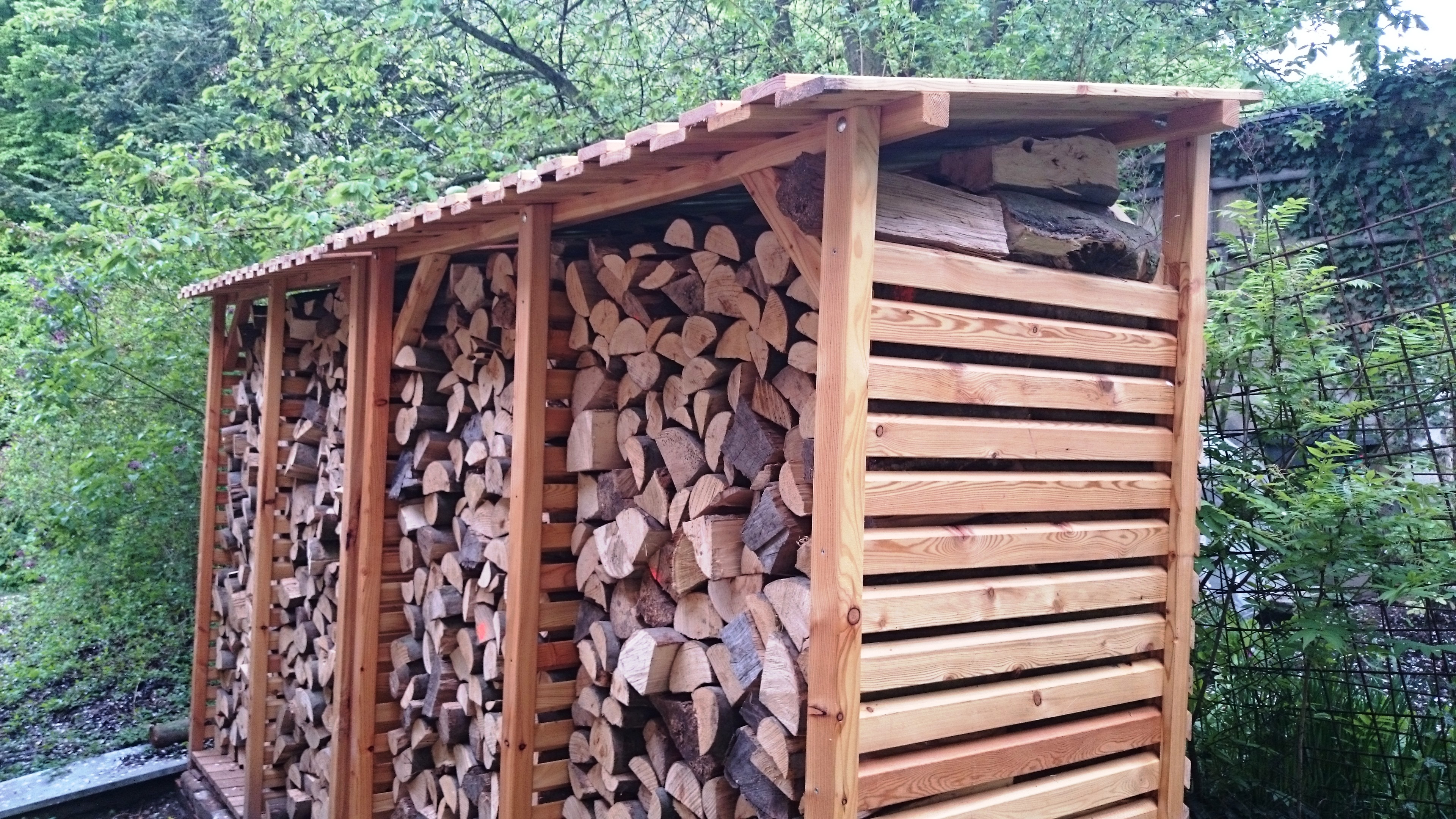 dřevník, ukládání dřeva, uložení dřeva, dřevo na topení, palivové dříví, dřevo do krbu. modřín